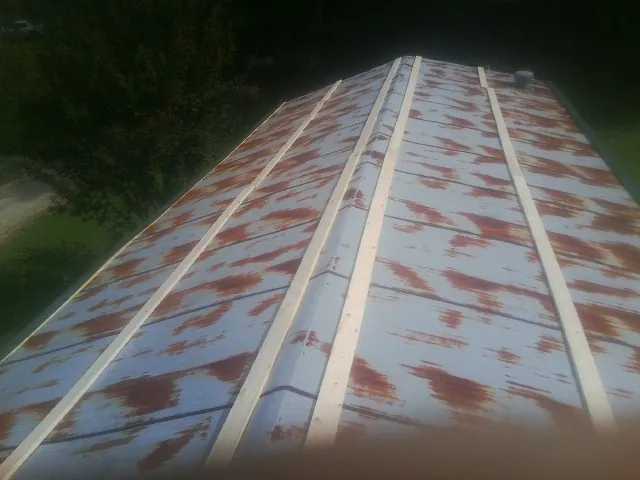 Rusted metal roof panels with new wood purlins before replacement — Storm Damage Roof Repair in Green Springs by Roofing Brothers