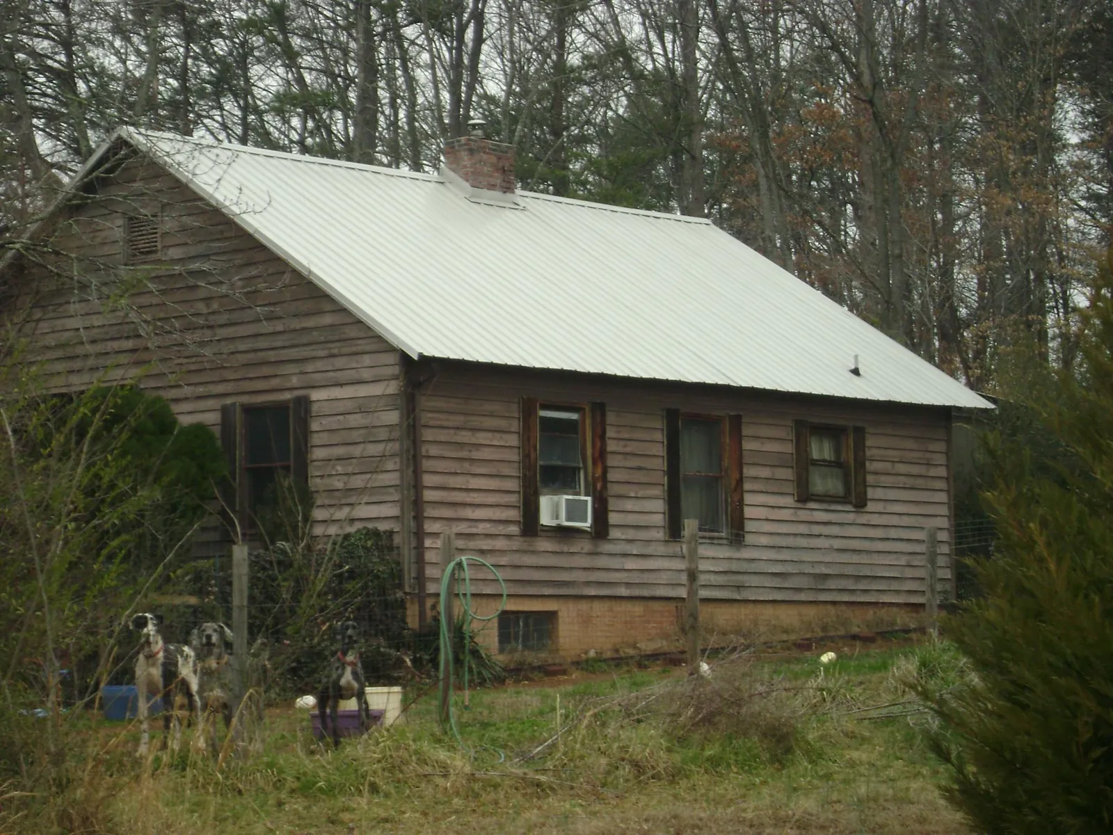 White metal roof on an old wood sided farmhouse, from a Metal Roof Installation job in Green Springs